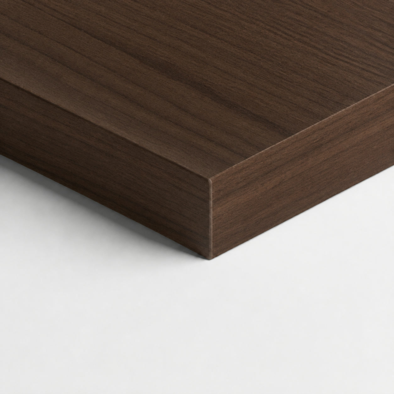 Veta Nogal surface — a dark natural walnut board with matched grain, edge in view