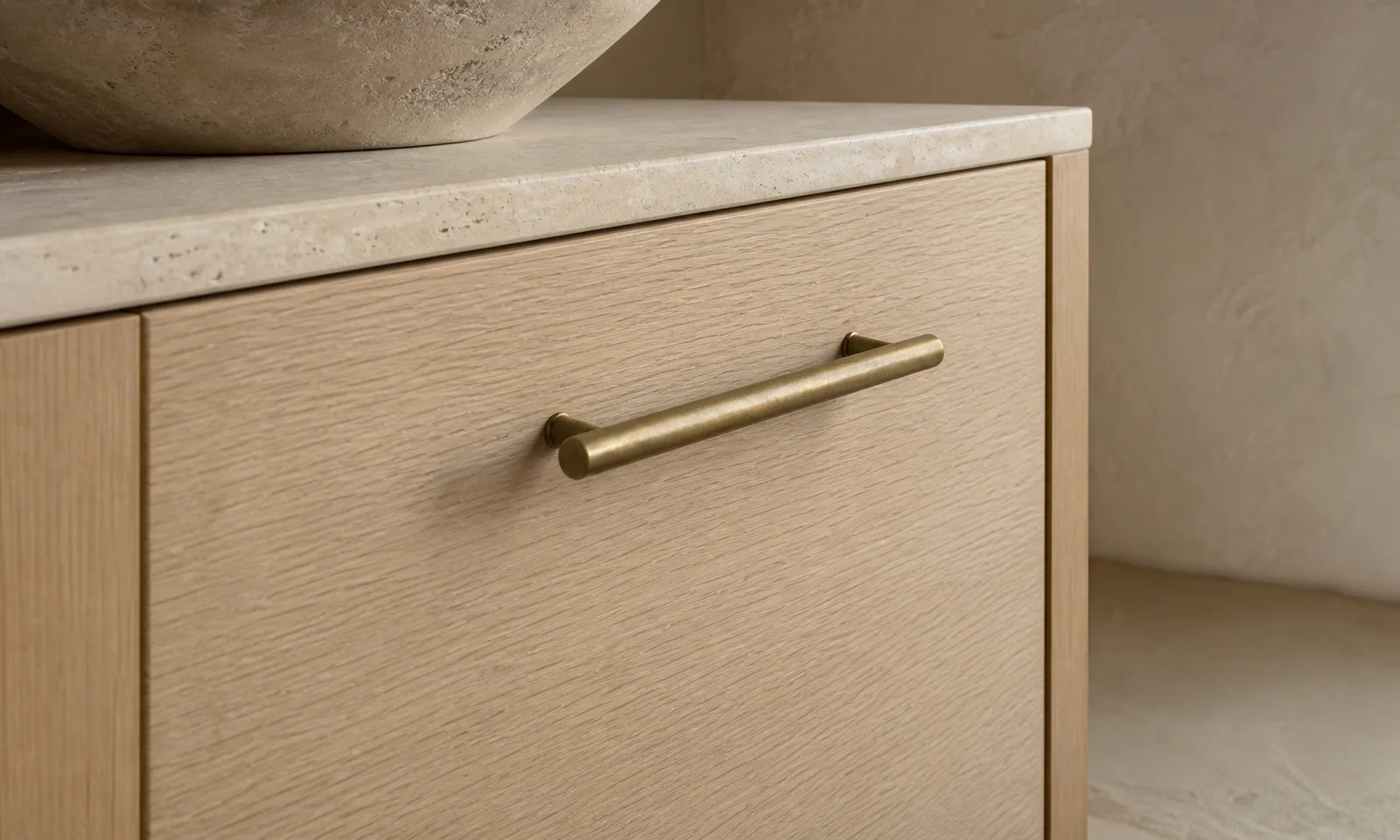Velora concept — dark bronze bar pulls on a bank of drawers